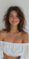 Woman in white top posing for picture photo