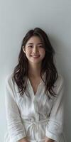 Smiling japanese woman sitting on chair photo