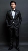 Man in tuxedo poses for picture photo