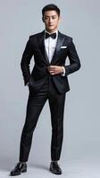 Man in tuxedo poses for picture photo