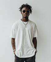 Man with dreadlocks standing in front of white wall photo