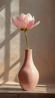 Pink vase with single flower photo