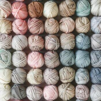 Assorted yarn balls arranged neatly photo