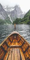 Boat sailing on water with mountains in background photo
