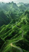 A road winding through a lush green valley photo