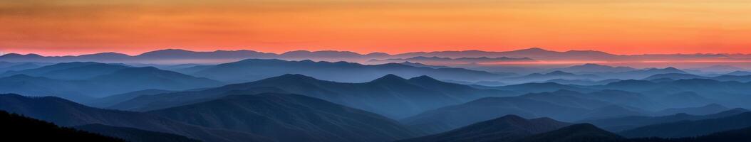 Majestic Mountain Range Illuminated by Sunset photo