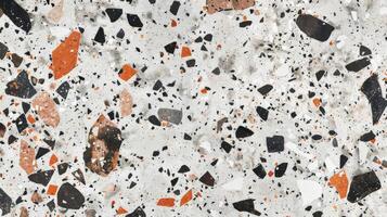 Marble surface with orange and black speckles photo
