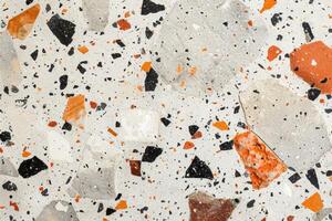Marble floor with orange and black speckles photo