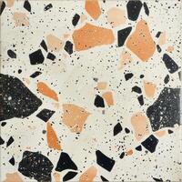 White Tile With Orange and Black Dots photo