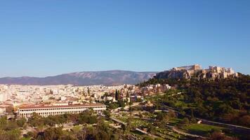 Rock of the Acropolis of Athens seen from afar. Symbol of ancient greece with blue sky background. Ancient architecture of Greek civilization. Ancient remains that attract tourists traveling in Grecce video