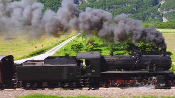 Spectacular steam train filmed in motion by a drone. Ancient locomotive that pulls carriages. train that runs on coal, snorts and makes a lot of smoke. Event where a historic means of transport passes video