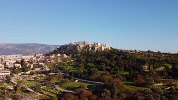 Rock of the Acropolis of Athens seen from afar. Symbol of ancient greece with blue sky background. Ancient architecture of Greek civilization. Ancient remains that attract tourists traveling in Grecce video