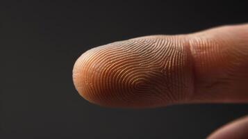Finger with friction ridges on dark background, macro view photo