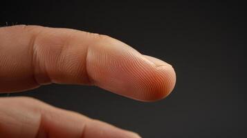 Finger with friction ridges on dark background, macro view photo