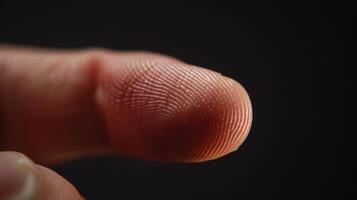 Finger with friction ridges on dark background, macro view photo