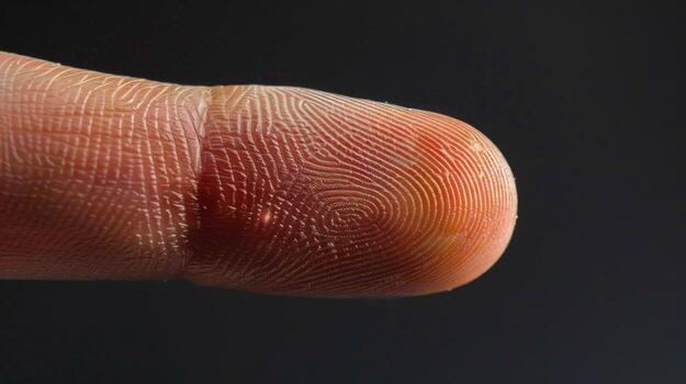 Finger with friction ridges on dark background, macro view photo