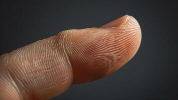 Finger with friction ridges on dark background, macro view photo