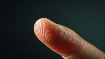 Finger with friction ridges on dark background, macro view photo
