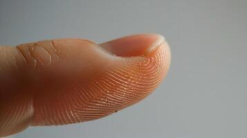 Finger with friction ridges on dark background, macro view photo
