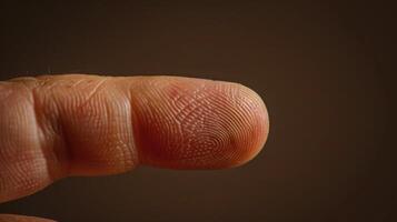 Finger with friction ridges on dark background, macro view photo