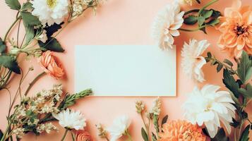 Flat lay of beautiful flowers over orange background and blank card for invitation. Mother's day, Valentine's day or wedding concept. Mock up template with space for text or product. photo