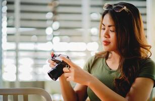 Asian photographer A beautiful girl who likes taking pictures with her trusty little camera. The art of photography and the passion for the work photo