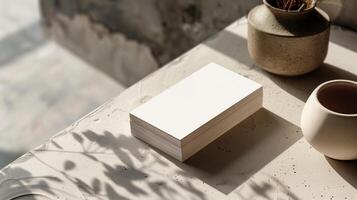 Stack of blank cards mockup set on textured stone surface with pottery. Warm and rustic atmosphere. Businesscard template advertising image. Stationery mock up product photorealistic photo