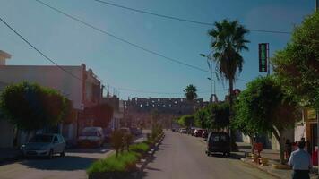 Road traffic view with an old architectural building at the end. video