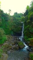 Smooth FPV flight of stunning tropical waterfall in the jungle in Indonesia. video