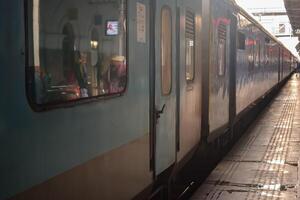 Delhi, India, July 09 2024 - Indian railway express train at departure from Anand Vihar railway station during morning time, Colourful Express train at Delhi railway station photo
