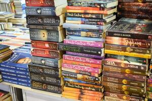 New Delhi, India, June 17 2024 - Variety of Books on shelf inside a book-stall at Delhi International Book Fair, Selection of books on display in Annual Book Fair at Bharat Mandapam complex photo