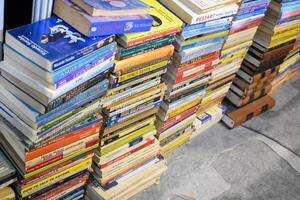 New Delhi, India, February 17 2024 - Variety of Books on shelf inside a book-stall at Delhi International Book Fair, Selection of books on display in Annual Book Fair at Bharat Mandapam complex photo