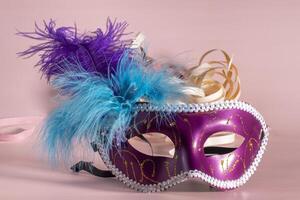 Venetian carnival mask with feathers, and typical elements in the background photo