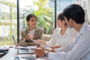 Diverse Team of Business Professionals Collaborating and Sharing Ideas in a Modern Office Setting photo
