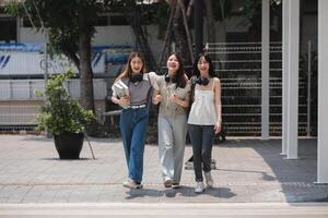 Group of happy students walking along the corridor at college photo