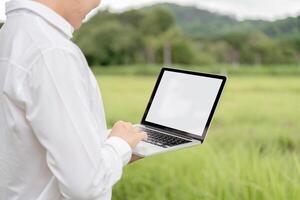 Agricultural Researchers Utilizing Modern Technology in Field for Enhanced Crop Analysis and Data Collection photo