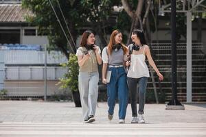 Group of happy students walking along the corridor at college photo