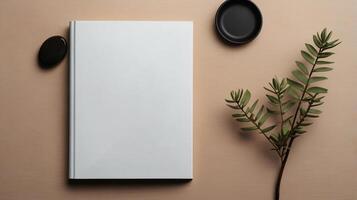 Book mockup design. Blank white book on dining table in aesthetic style with tableware, copy space photo