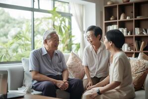 A diverse mix of Asian elderly individuals gathers in a nursing home, seated and engaged in conversation, fostering companionship, sharing stories, and exchanging wisdom in a harmonious photo