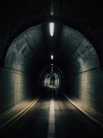 a long tunnel with a light at the end photo