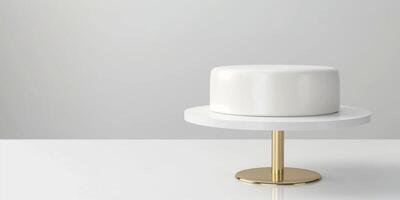 Minimalist white cake on modern stand on white and golden background in bright interior dessert food concept with copy space photo