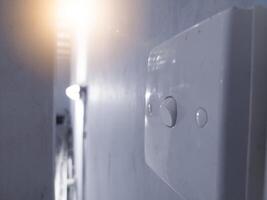 Close up the Switch lamp on the wall building interior in industry. photo
