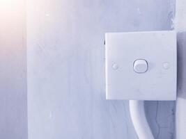 Close up the Switch lamp on the wall building interior in industry. photo