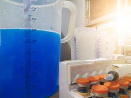 Mixing chicken vaccine medication with solvent, the process of making a dose of chicken vaccine spray medication. photo