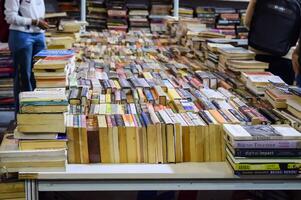New Delhi, India, February 17 2024 - Variety of Books on shelf inside a book-stall at Delhi International Book Fair, Selection of books on display in Annual Book Fair at Bharat Mandapam complex photo
