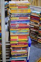 New Delhi, India, February 17 2024 - Variety of Books on shelf inside a book-stall at Delhi International Book Fair, Selection of books on display in Annual Book Fair at Bharat Mandapam complex photo