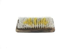 Old traditional manual clothes brusher made of wood on white background. Isolated white background. photo