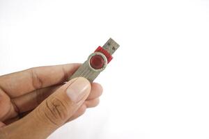 Man's hand holding a red usb drive or flashdisk on a white background. isolated white background photo