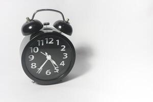 Classic black table clock isolated on a white background. copy space photo