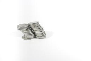 collection of Indonesian rupiah coins on a white background. Stack of Indonesian rupiah coins. Stack of Silver Coins. Financial concept. Copy space. isolated on white photo
